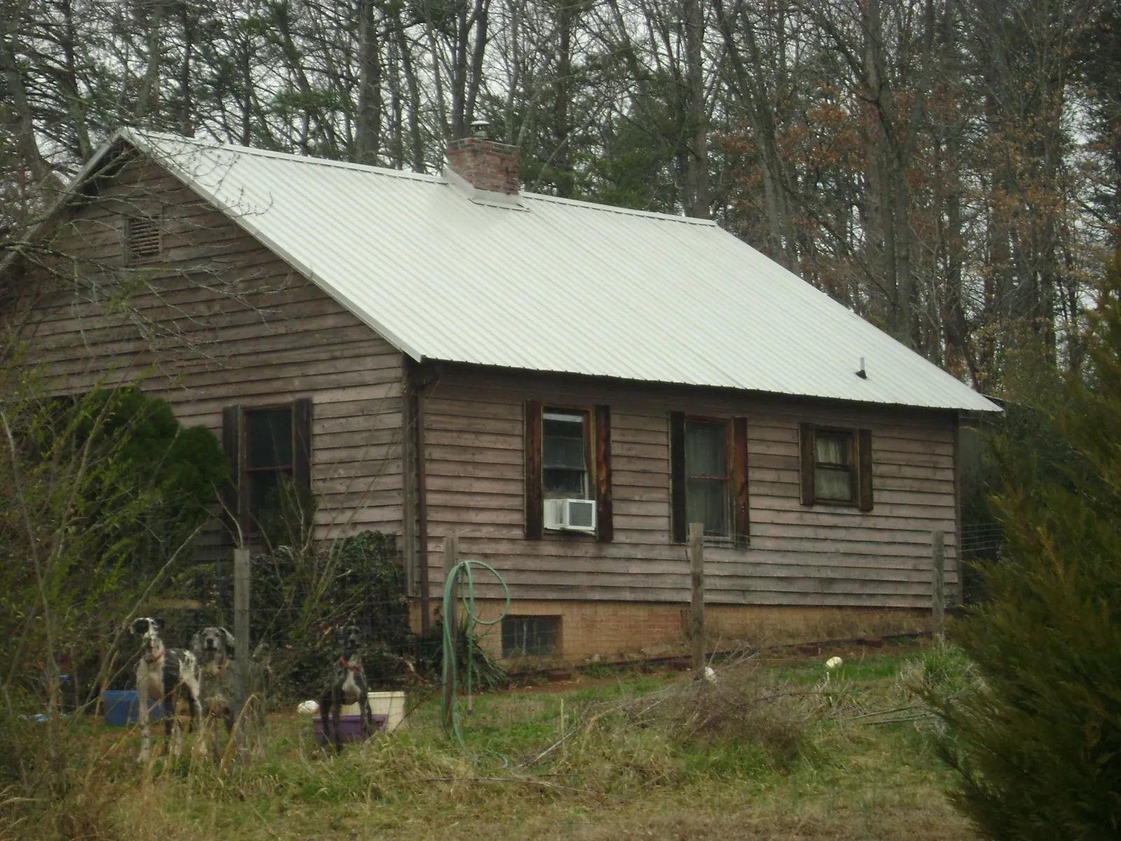 White metal roof on an old wood sided farmhouse, from a Metal Roof Installation job in Hawthorne